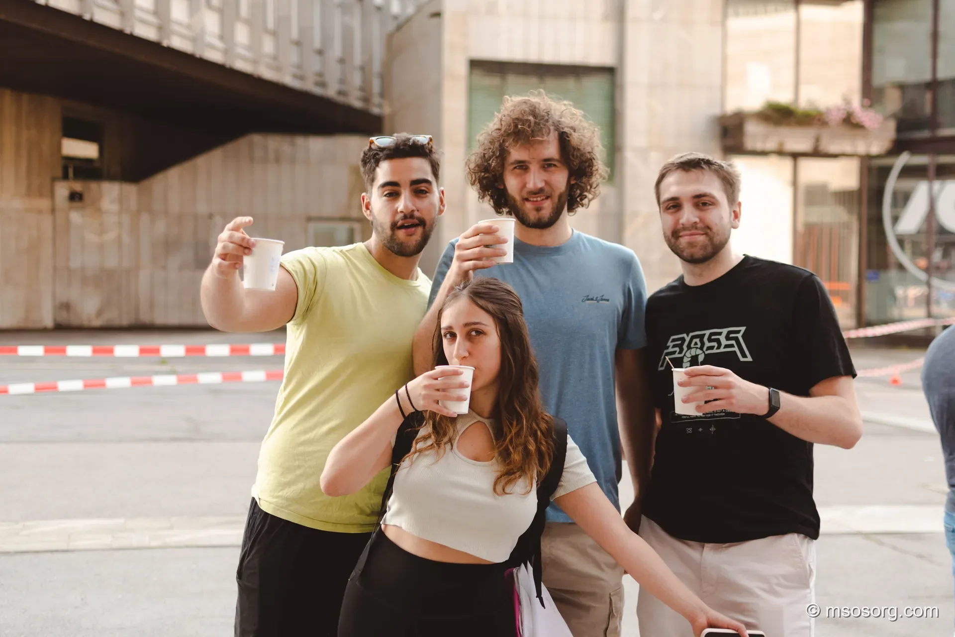 A group of students with hot coffee posing for the camera.