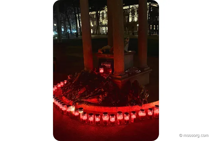 A sea of candles and flowers left by attendees