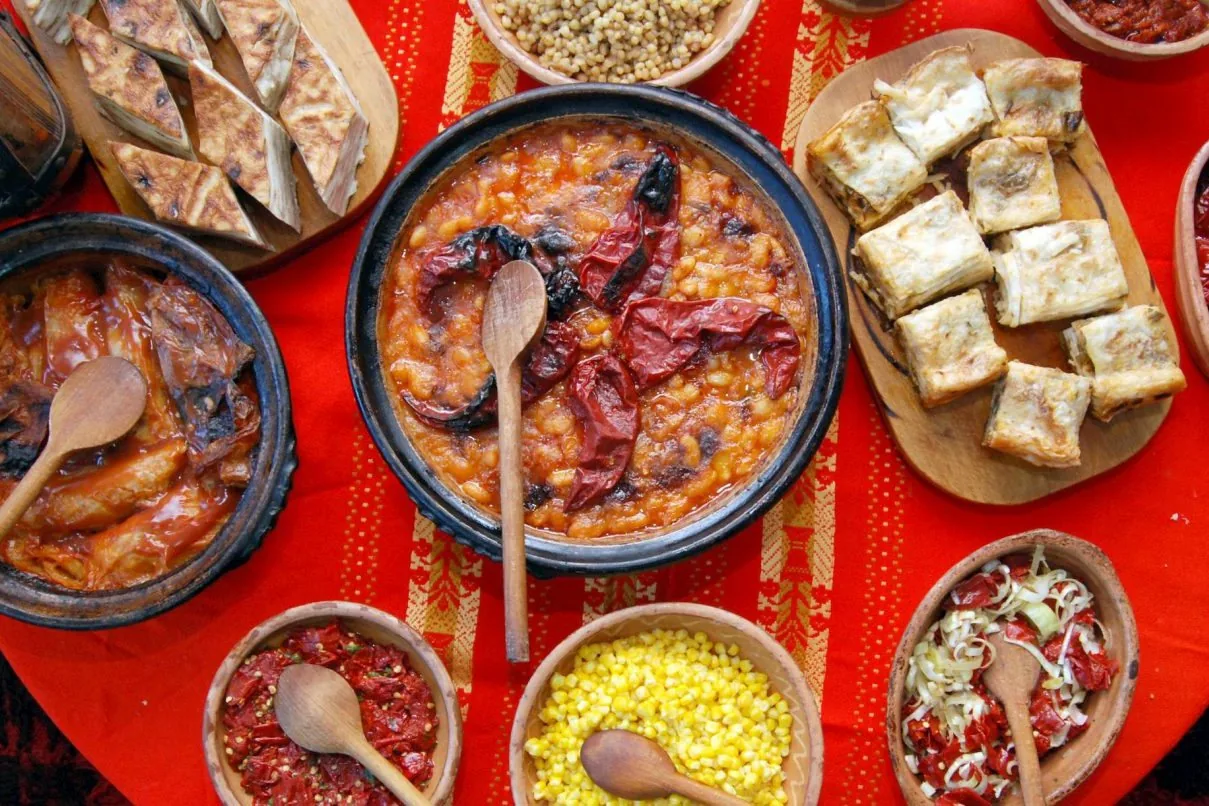A shared Macedonian table with salads, bread, beans, and other dishes